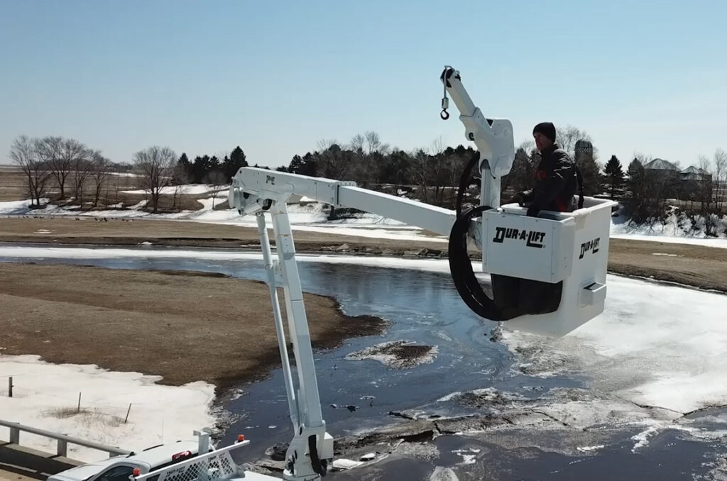 Man in DPM2-52's bucket raised in the air