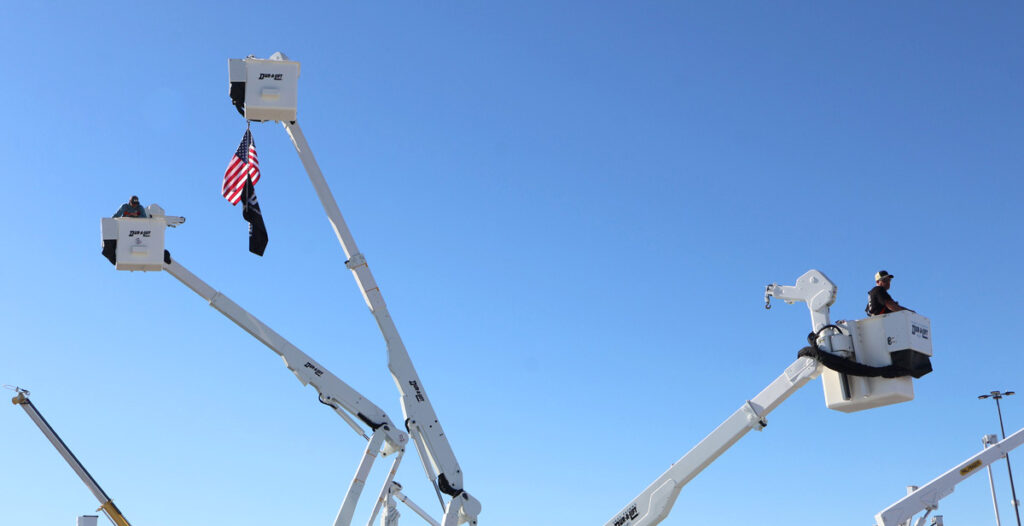 Aerial view of people test flying bucket trucks at The Utility Expo.